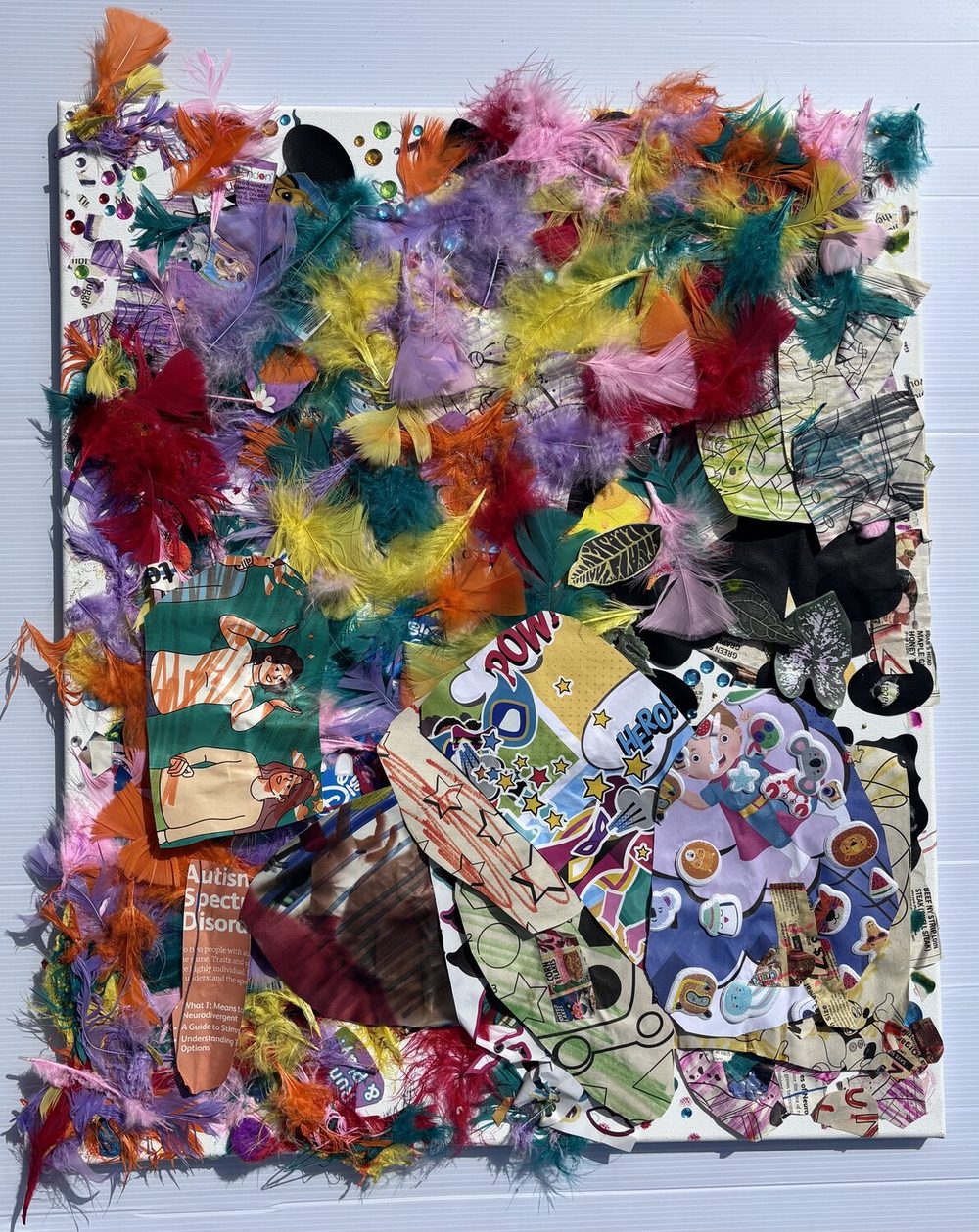 Mixed media collage of colorful feathers, paper, and fabric.